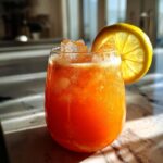 Carrot Ginger Cooler Mocktail – Earthy carrot juice with zesty ginger and lemon over ice.