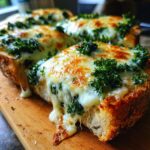 Close-up of The Best Cheesy Kale Garlic Bread slices on a wooden board, with melted cheese dripping down.