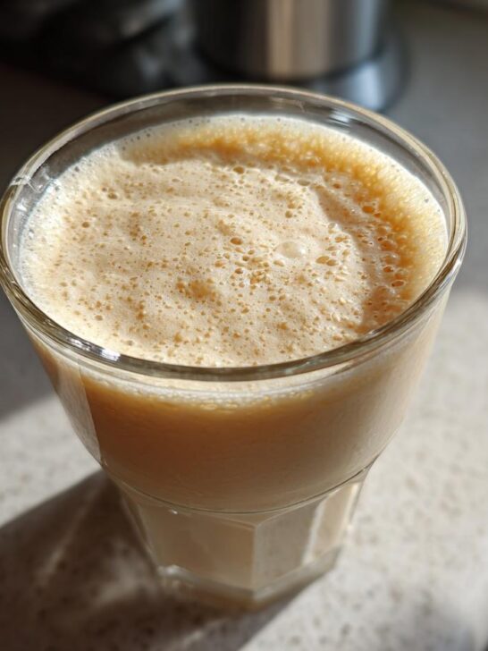 A glass filled with creamy vanilla sesame milk, topped with a frothy layer.