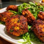 Close-up of golden-brown veggie patties served on a bed of fresh greens, part of 10 Healthy Dinner Recipes For Weight Loss.