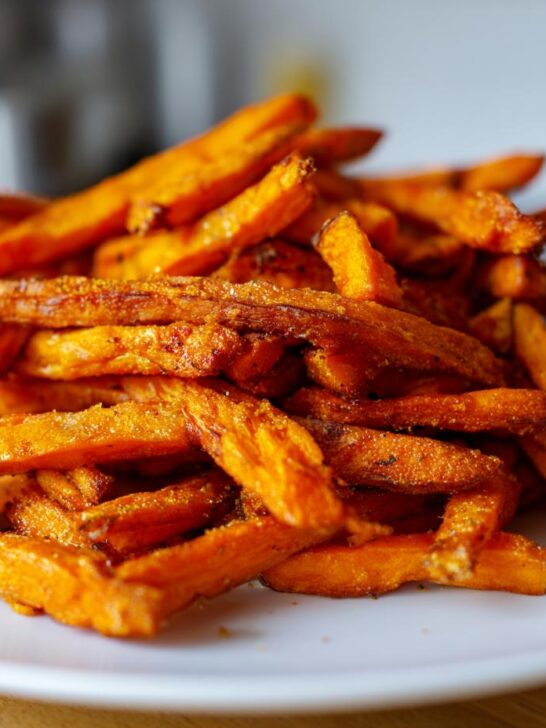 A pile of Irresistible Sweet Potato Fries, perfectly seasoned and baked to a crispy delight.