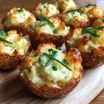 Close-up of Irresistible Twice Baked Potato Bites, golden brown and topped with fresh chives.