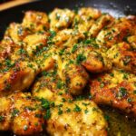 Close-up of tender pieces of Lemon Chicken With Lemon Butter Sauce, garnished with fresh parsley.