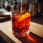 A perfectly crafted Negroni cocktail in a crystal glass, garnished with an orange peel, showcasing the best vermouths for Negronis.