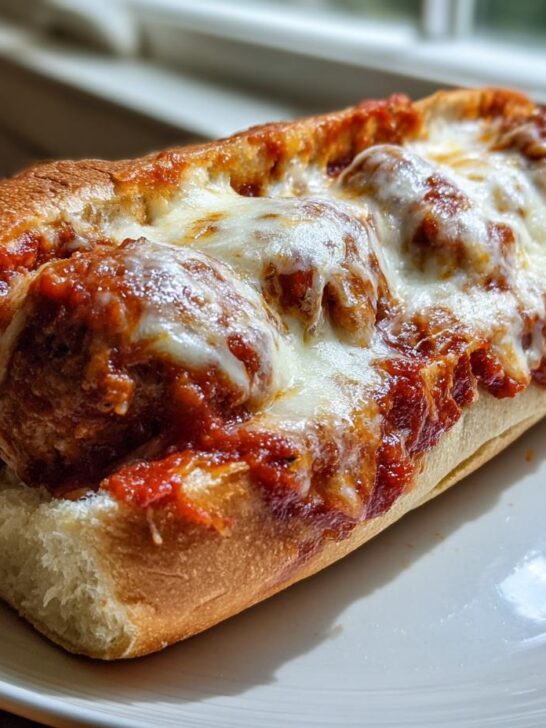 Close-up of a delicious Meatball Subs sandwich loaded with meatballs, marinara sauce, and melted mozzarella cheese.
