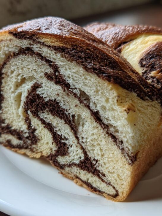 Close-up of a slice of soft Chocolate Marble Asian Bread showing beautiful swirls of chocolate filling.