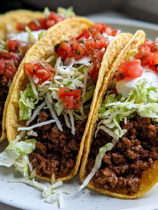Three crispy tacos filled with seasoned ground turkey, shredded lettuce, sour cream, and pico de gallo: Healthy Ground Turkey Tacos.