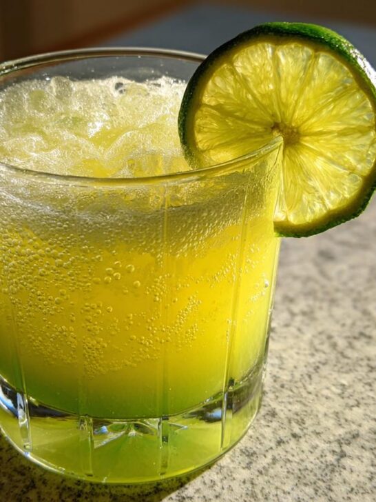 Close-up of a fizzy Pineapple Jalapeno Lime Mocktail garnished with a bright lime wheel.