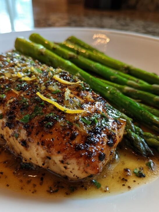 Close-up of pan-seared salmon with lemon-herb sauce and asparagus, perfect for Quick Dinner Recipes In 20 Minutes.