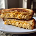Cross-section of a grilled sandwich showing creamy tuna and melted cheddar cheese, perfect for Quick Dinner Recipes.