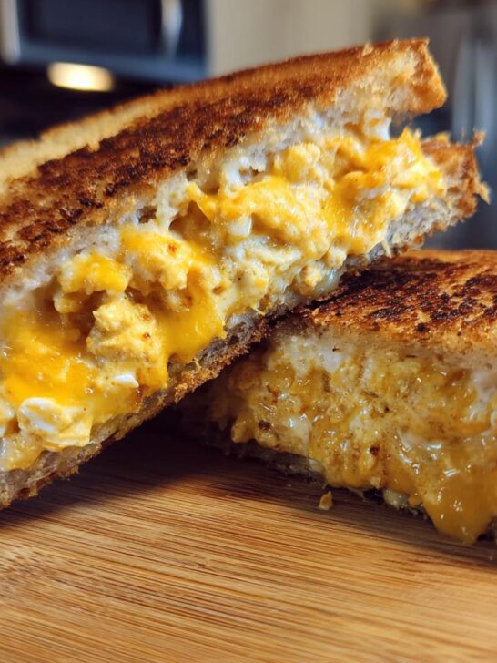 Cross-section of a grilled tuna melt sandwich showing creamy tuna salad and melted cheese, perfect for quick dinner recipes.