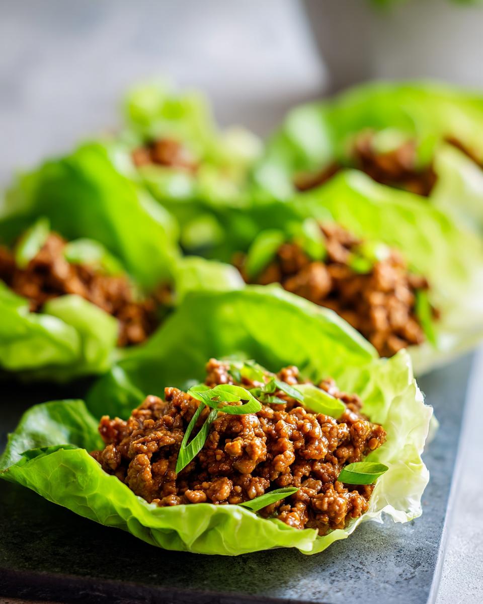 Close-up of Mexican Ground Beef Lettuce Wraps filled with seasoned ground beef and topped with green onions.