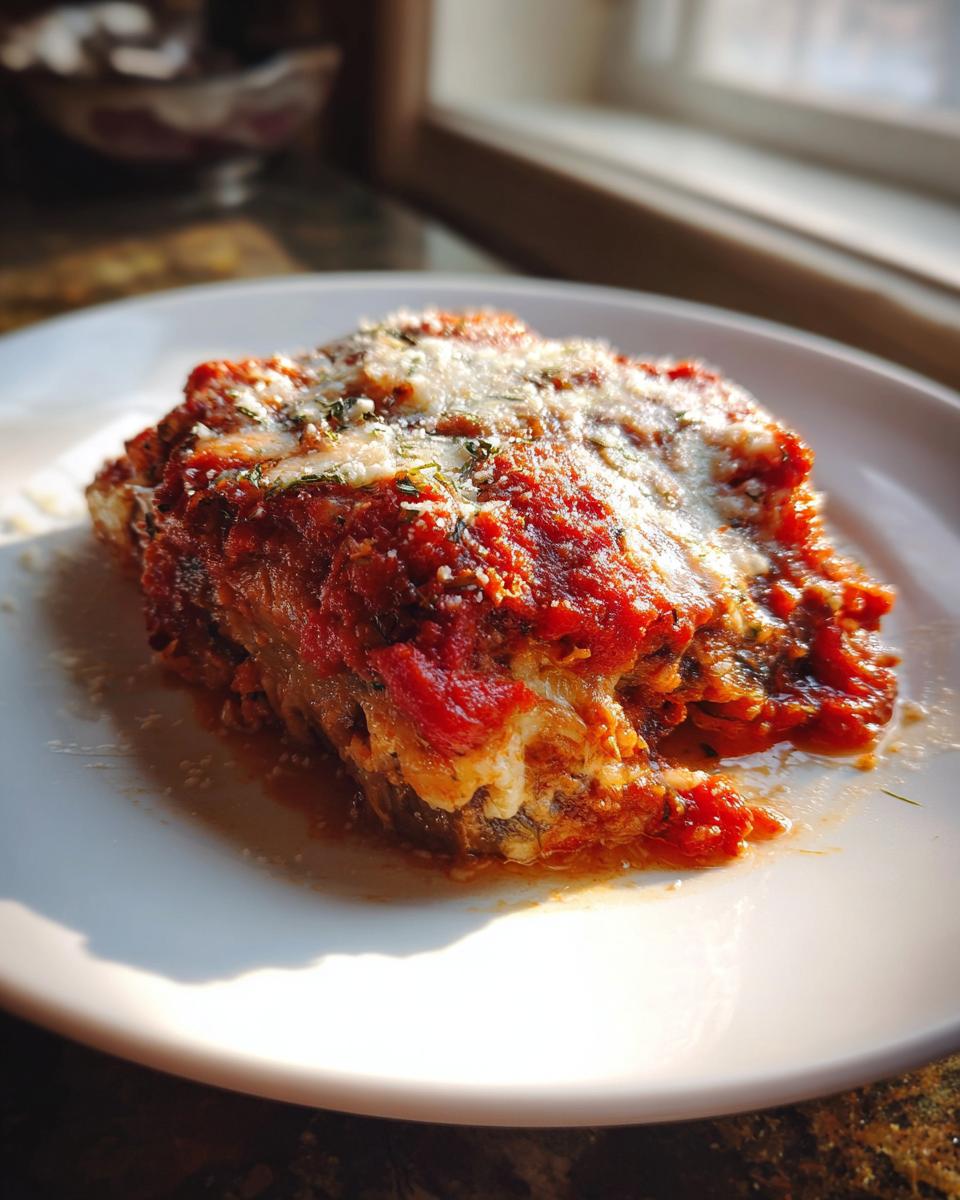 A close-up serving of My Italian Grandmothers Eggplant Recipe, baked with rich tomato sauce and melted cheese.